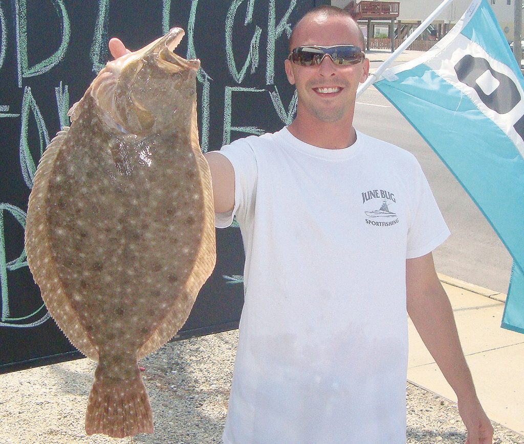 An angler shows off his fluke caught in Barnegat Bay. (Photo: Jersey Shore Fishing Magazine)