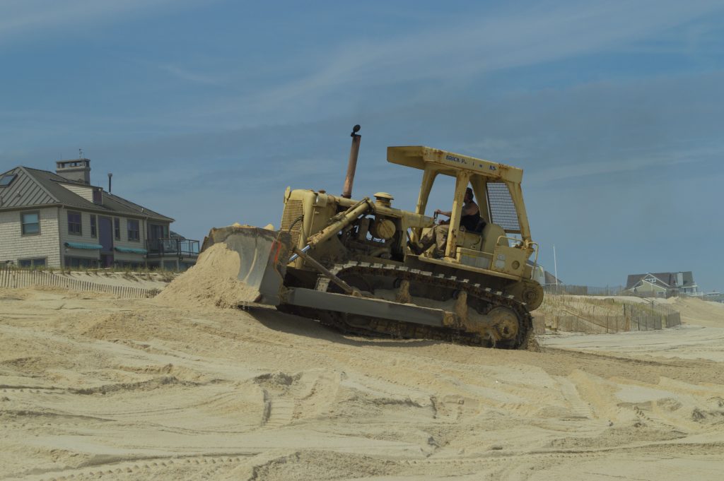 A bulldozer moves sand on Brick Beach III, May 11, 2016. (Photo: Daniel Nee)