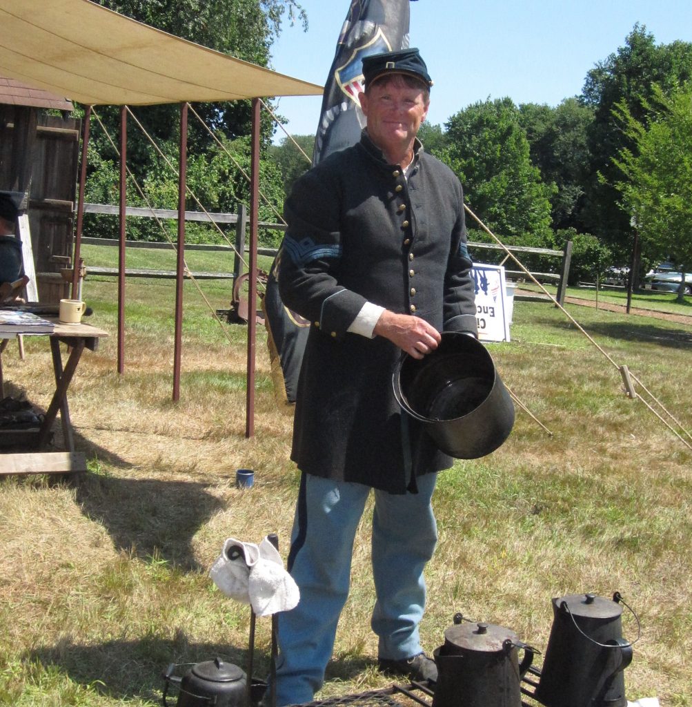 Jim Heine of Manasquan demonstrating how the soldiers cooked. (Photo: Brick Historical Society)