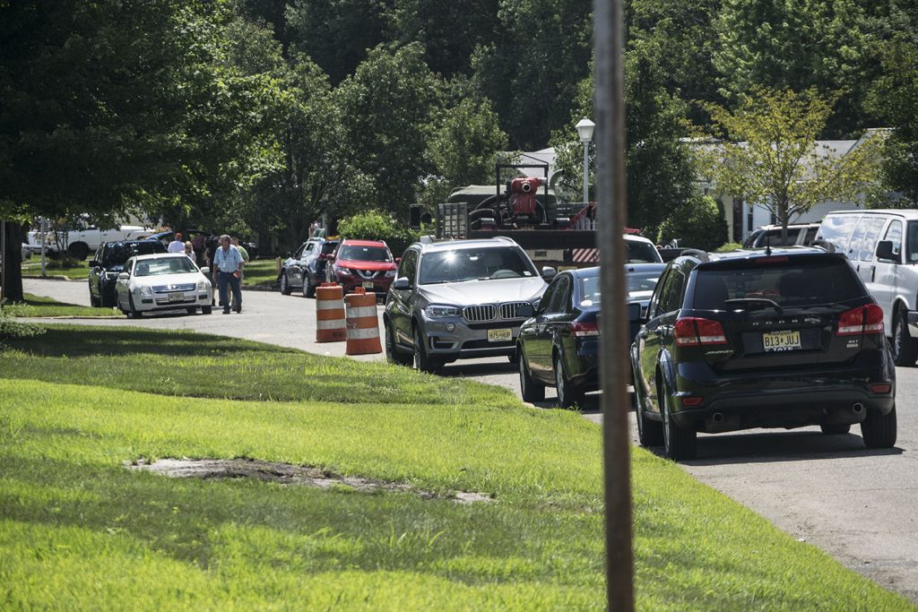 Cars line a street in Greenbriar I as residents clean out damaged homes. (Photo: Daniel Nee)
