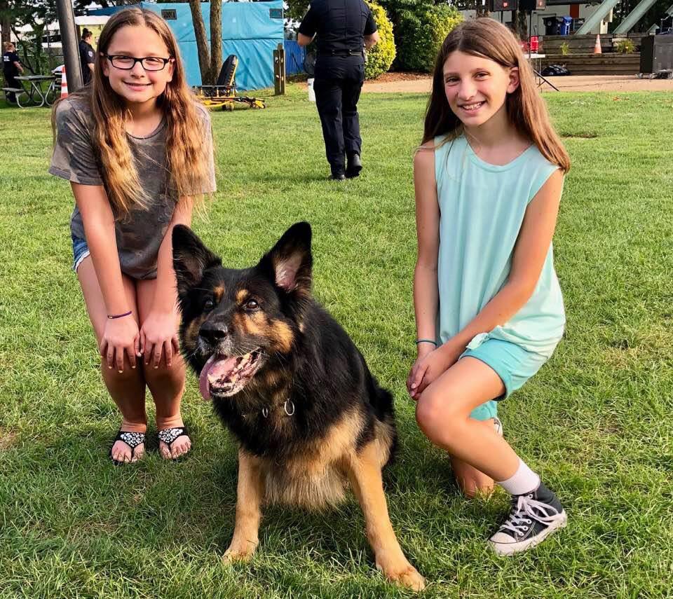 Maya Jackson and Colleen Crate with one of Brick Township's police dogs. (File Photo)