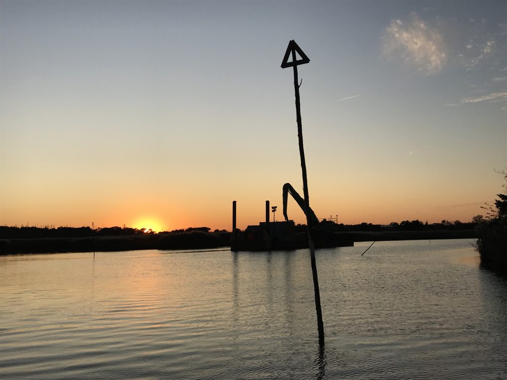 A dredge barge in the distance at sunset, Oct. 16, 2019. (Photo: Daniel Nee)
