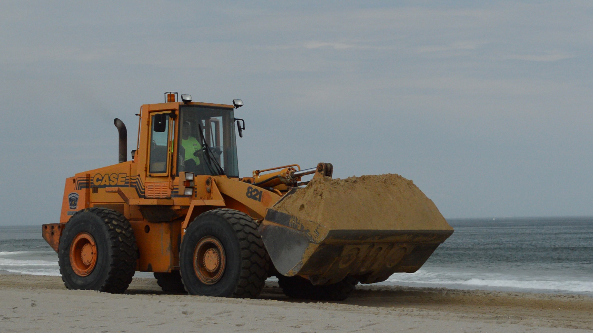 A truck transports sand to a waiting bulldozer at Brick Beach III, May 24, 2016. (Photo: Daniel Nee)