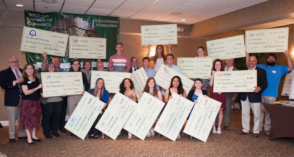 Oversized checks, donated by FASTSIGNS of Brick and representing $23,000 in awards to local scholars. (Photo: Brick Township Chamber of Commerce)