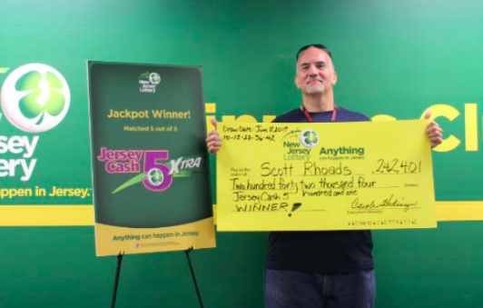 Scott Rhoads, of Brick, with his lottery winning check. (Photo: NJ Lottery)