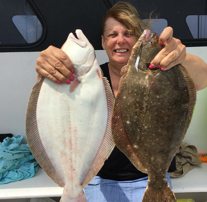 A happy customer with two keeper fluke on board the Gambler party boat. (Photo: Gambler Crew)