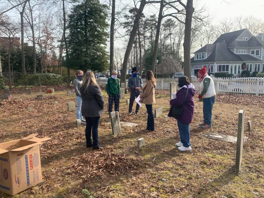 Members of the Brick Township Historical Preservation Commission plant wreaths at the Wooley Cemetery in Brick. (Photo: Brick Township)
