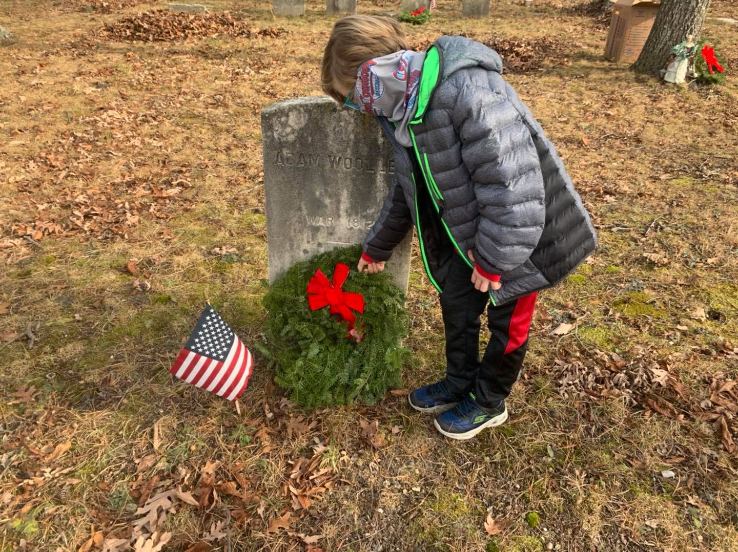 Members of the Brick Township Historical Preservation Commission plant wreaths at the Wooley Cemetery in Brick. (Photo: Brick Township)