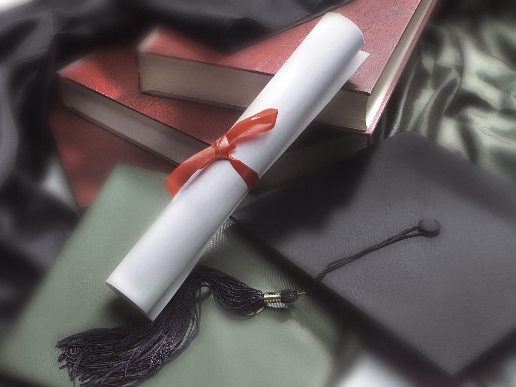 Graduation cap and diploma. (Credit: Creative Commons/ Graduation & Safe Driving/ State Farm)