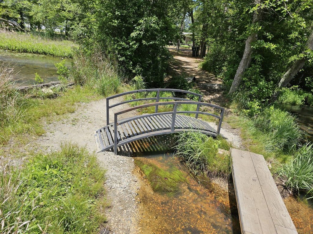 A makeshift bridge to help pedestrians navigate the walking path at Godfrey Lake, Brick, N.J. (Credit: Kevin Boggio/ Facebook)