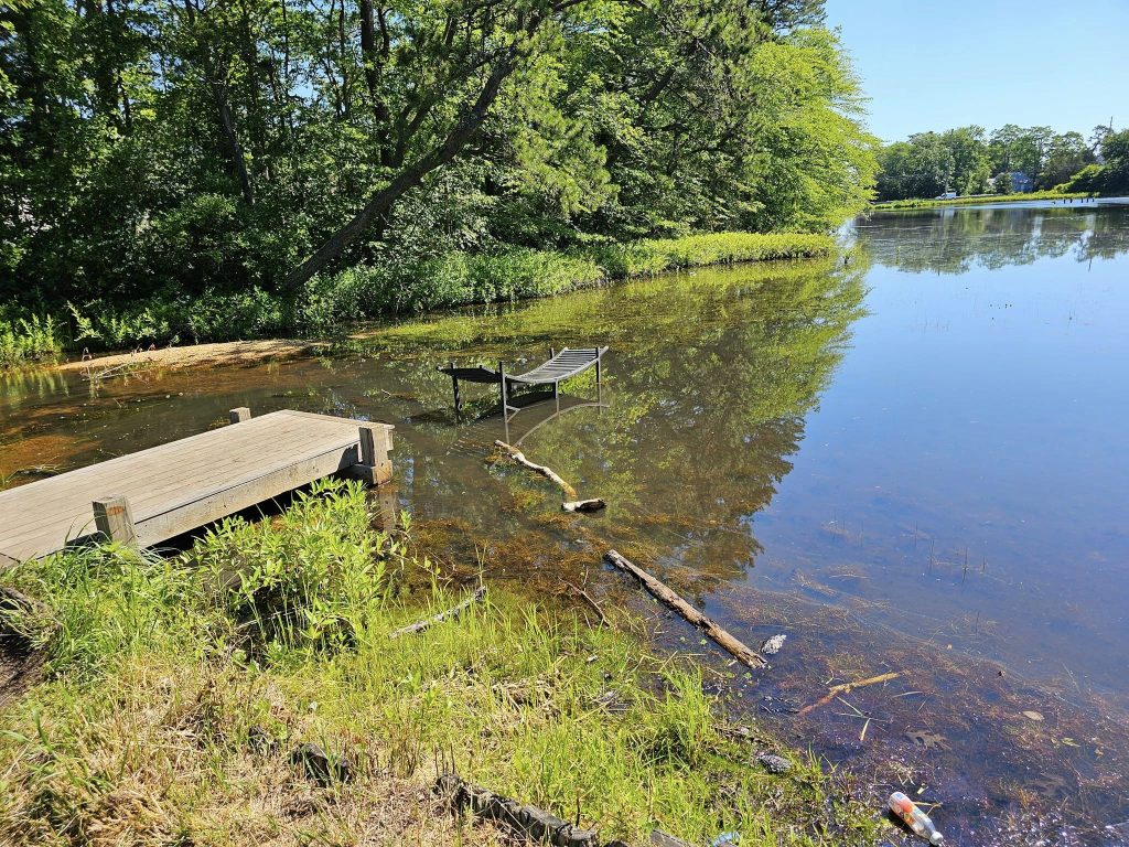 A makeshift bridge to help pedestrians navigate the walking path at Godfrey Lake, Brick, N.J. (Credit: Kevin Boggio/ Facebook)