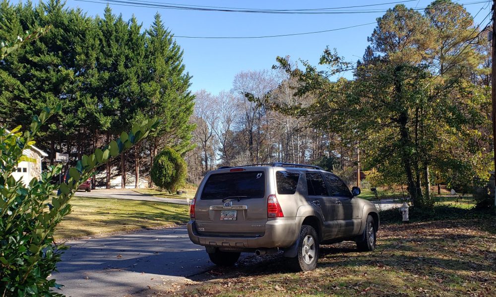 A car parked on a front lawn. (Source: Reddit/Submitted File)