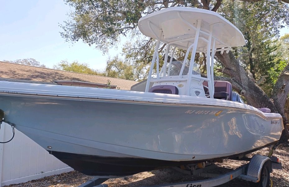 A boat rests on a trailer in a yard. (Photo: Shorebeat)