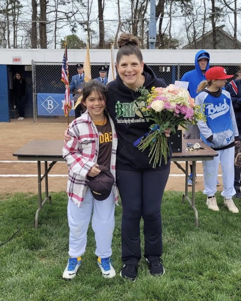 Mayor Lisa Crate joins girls from the Brick Little League program as they begin their season in 2024. (Photo: Brick Little League)